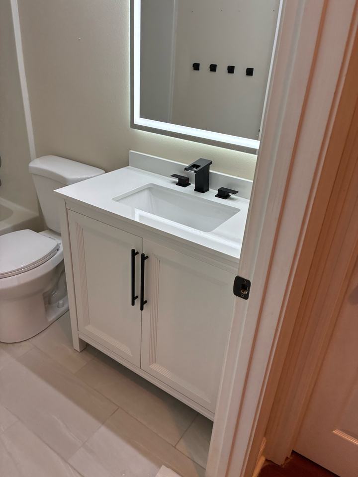 White shaker vanity with black faucet and hardware
